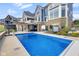 Beautiful backyard pool area with hot tub, outdoor kitchen, and ample space for entertaining at 20451 Chatham Hills Blvd, Westfield, IN 46074