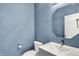Stylish powder room featuring blue walls, modern fixtures, and a sleek vanity at 20451 Chatham Hills Blvd, Westfield, IN 46074