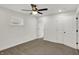 This bedroom offers carpeted floors, a ceiling fan, white walls, and multiple doors at 2137 Napoleon St, Indianapolis, IN 46203