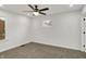 This carpeted bedroom features a ceiling fan, white walls, and a window for natural light at 2137 Napoleon St, Indianapolis, IN 46203
