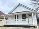 Charming renovated one-story home featuring a covered porch and fresh white exterior at 2137 Napoleon St, Indianapolis, IN 46203