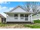 Charming single-story home with a covered front porch, white siding, and a well-maintained yard at 2137 Napoleon St, Indianapolis, IN 46203