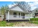 Charming single-story home with a covered front porch, white siding, and a well-maintained yard at 2137 Napoleon St, Indianapolis, IN 46203