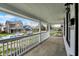 Inviting front porch with white railings, offering a glimpse of the neighborhood street and charming homes at 2137 Napoleon St, Indianapolis, IN 46203