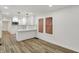 Bright kitchen featuring white cabinets, countertops, a tile backsplash, and modern pendant lighting at 2137 Napoleon St, Indianapolis, IN 46203