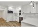 This stylish kitchen offers white cabinets, quartz counters, and stainless steel appliances at 2137 Napoleon St, Indianapolis, IN 46203