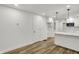 Modern kitchen with white cabinets, countertops, and a view of the adjacent living space at 2137 Napoleon St, Indianapolis, IN 46203