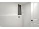 Bright laundry room featuring white walls, dark window and utility connections for washer and dryer at 2137 Napoleon St, Indianapolis, IN 46203