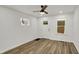 Bright living room featuring new floors, fresh paint, new ceiling fan and natural light from the windows at 2137 Napoleon St, Indianapolis, IN 46203