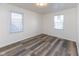Cozy bedroom with modern flooring and bright natural light from two windows at 2306 Finley Ave, Indianapolis, IN 46203
