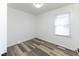 Bedroom with hardwood-style floors and a window at 2306 Finley Ave, Indianapolis, IN 46203