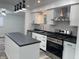 Modern kitchen features new stainless steel appliances and black and white backsplash at 2306 Finley Ave, Indianapolis, IN 46203