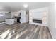 Open-concept living room with wood-look floors, fireplace, and an open view to the kitchen at 2306 Finley Ave, Indianapolis, IN 46203