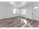 Bright living room with a front door, a large window, and wood-look floors at 2306 Finley Ave, Indianapolis, IN 46203