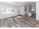 Spacious living room featuring wood-look floors with ample natural light and an adjacent kitchen at 2306 Finley Ave, Indianapolis, IN 46203