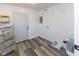 Mud room with hardwood-style floors, a door, and a ladder at 2306 Finley Ave, Indianapolis, IN 46203