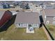 Aerial view of a cozy backyard with a small patio set, surrounded by a well-kept lawn and wooden fence at 293 Carrick Glen Blvd, Pendleton, IN 46064