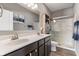 A well-lit bathroom has double sinks, modern fixtures, and a glass-enclosed shower at 293 Carrick Glen Blvd, Pendleton, IN 46064