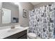 Traditional bathroom with a white vanity, cat-themed shower curtain, and framed artwork at 293 Carrick Glen Blvd, Pendleton, IN 46064
