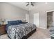 This relaxing bedroom has plush carpet, a ceiling fan, and ample natural light at 293 Carrick Glen Blvd, Pendleton, IN 46064