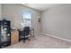 Neutral bedroom with a window providing natural light and a workspace including a desk and rolling chair at 293 Carrick Glen Blvd, Pendleton, IN 46064