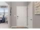 Bright entryway featuring a white front door, wood-look floors, and modern decor at 293 Carrick Glen Blvd, Pendleton, IN 46064