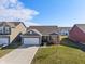Attractive one-story home featuring a brick facade, well-kept lawn, and an attached two-car garage in a residential area at 293 Carrick Glen Blvd, Pendleton, IN 46064