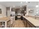 A spacious kitchen features stainless steel appliances, dark cabinets, and a breakfast bar with pendant lighting at 293 Carrick Glen Blvd, Pendleton, IN 46064