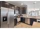 Well-equipped kitchen with stainless steel appliances, dark cabinets, and modern fixtures at 293 Carrick Glen Blvd, Pendleton, IN 46064
