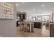 Open-concept kitchen with dark cabinetry, stainless steel appliances, adjacent to a living area with a ceiling fan at 293 Carrick Glen Blvd, Pendleton, IN 46064