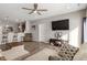 Open living room with a ceiling fan and a flat screen TV is connected to the kitchen at 293 Carrick Glen Blvd, Pendleton, IN 46064