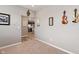 Cozy carpeted living room with gray walls, stylish decor, and an open view to the kitchen at 293 Carrick Glen Blvd, Pendleton, IN 46064
