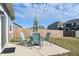 Outdoor patio showcasing a dining set and umbrella, perfect for entertaining guests in a private backyard setting at 293 Carrick Glen Blvd, Pendleton, IN 46064