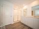 The bathroom features dual sinks, a large mirror, white cabinets, and a glass-enclosed shower at 3261 W Keepsake Ln, Monrovia, IN 46157