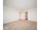 Spacious bedroom with neutral carpet, white walls, and a view of the hallway at 3261 W Keepsake Ln, Monrovia, IN 46157