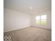 This bright bedroom features tan carpet and a large window for plenty of natural light at 3261 W Keepsake Ln, Monrovia, IN 46157