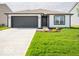 Charming single-story home boasting manicured lawn and modern black and white accents at 3261 W Keepsake Ln, Monrovia, IN 46157