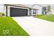 Inviting single-story home with a large driveway and lush green lawn at 3261 W Keepsake Ln, Monrovia, IN 46157