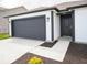 Attractive single-story home featuring a black garage door and white siding at 3261 W Keepsake Ln, Monrovia, IN 46157