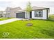 Well-maintained single-story home with green lawn, black garage door, and contrasting trim at 3261 W Keepsake Ln, Monrovia, IN 46157