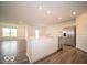 This kitchen features a center island with a sink, stainless steel appliances, and vinyl floors at 3261 W Keepsake Ln, Monrovia, IN 46157