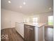 Well-lit kitchen features a center island with a stainless steel dishwasher and a sink at 3261 W Keepsake Ln, Monrovia, IN 46157