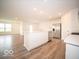 Open-concept kitchen with white cabinets, stainless appliances, and eat-in island at 3261 W Keepsake Ln, Monrovia, IN 46157