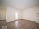 A view of a well-lit living room with vinyl floors and a back door at 3261 W Keepsake Ln, Monrovia, IN 46157