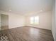 Open-concept living room with hard surface flooring and bright natural light at 3261 W Keepsake Ln, Monrovia, IN 46157