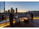 Scenic balcony featuring a fire pit, chairs, and stunning city views, perfect for outdoor relaxation and entertaining at 333 Massachusetts Ave # 801, Indianapolis, IN 46204