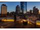Inviting balcony with a modern fire pit, comfortable seating, and panoramic views of the downtown skyline at 333 Massachusetts Ave # 801, Indianapolis, IN 46204