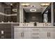 Modern bathroom with a double sink vanity, a large mirror, and decorative lighting at 333 Massachusetts Ave # 801, Indianapolis, IN 46204