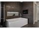 Modern bathroom featuring a sleek soaking tub, contemporary tile, and recessed shelving at 333 Massachusetts Ave # 801, Indianapolis, IN 46204