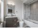 Bathroom featuring granite counters, wood cabinets, brushed silver finishes, and modern glass enclosed shower at 333 Massachusetts Ave # 801, Indianapolis, IN 46204